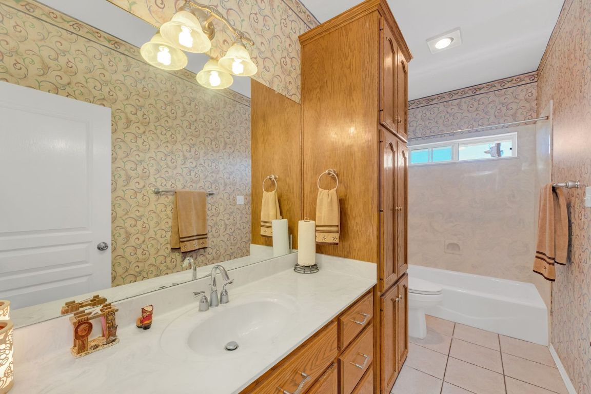 1949 Farm To Market Road 619 Elgin, TX 78621 - Photo 20 of 36 a bathroom with a sink vanity tub and a mirror