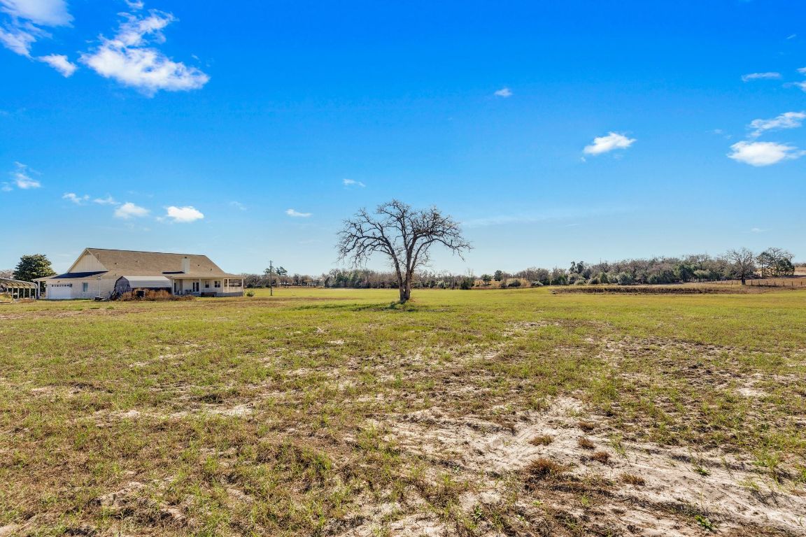 1949 Farm To Market Road 619 Elgin, TX 78621 - Photo 30 of 36 View of green lawn with a view of countryside