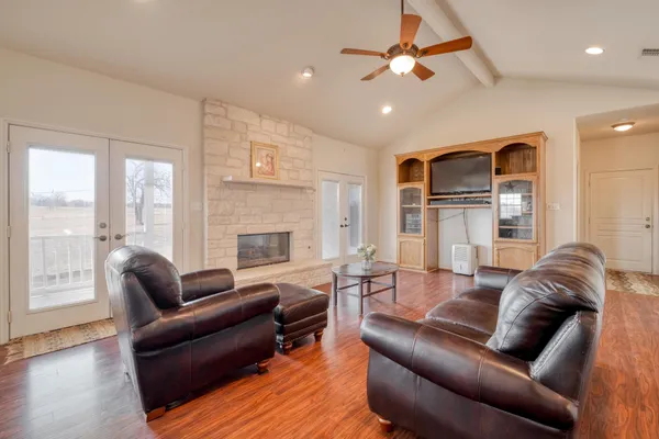 a living room with furniture ceiling fan and a fireplace