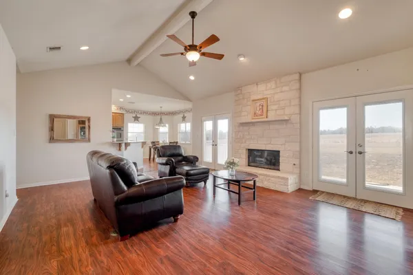 a living room with furniture wooden floor and a fireplace