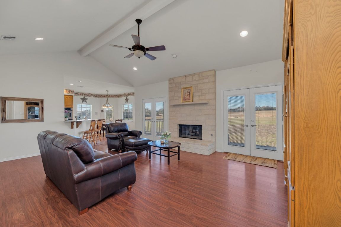 1949 Farm To Market Road 619 Elgin, TX 78621 - Photo 8 of 36 a living room with furniture a fireplace and wooden floor