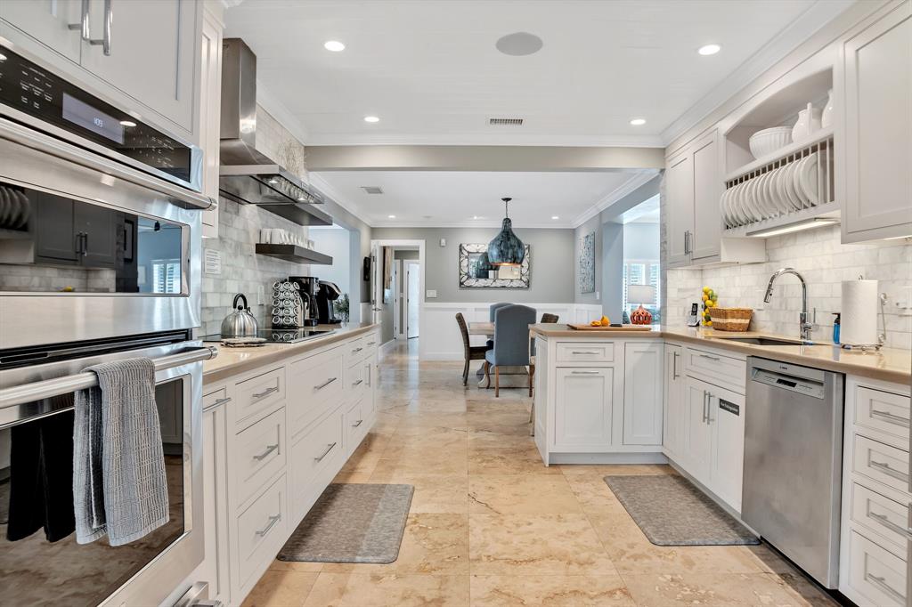 2013 Northeast 32nd Avenue Fort Lauderdale, FL 33305 - Photo 13 of 50 a kitchen with white cabinets and appliances