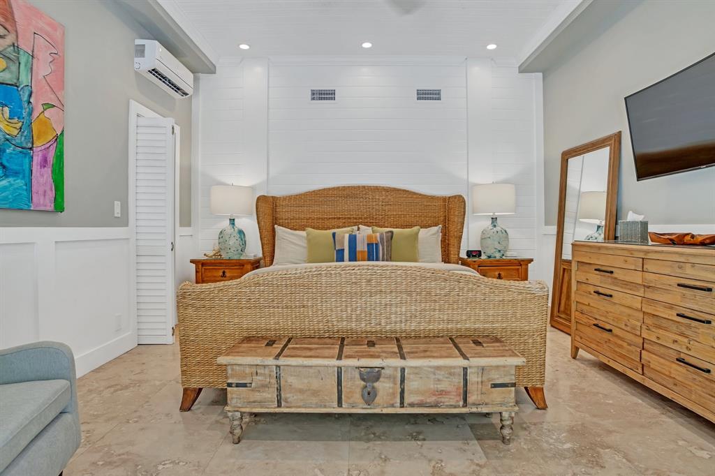 2013 Northeast 32nd Avenue Fort Lauderdale, FL 33305 - Photo 22 of 50 a bedroom with a bed and a flat screen tv