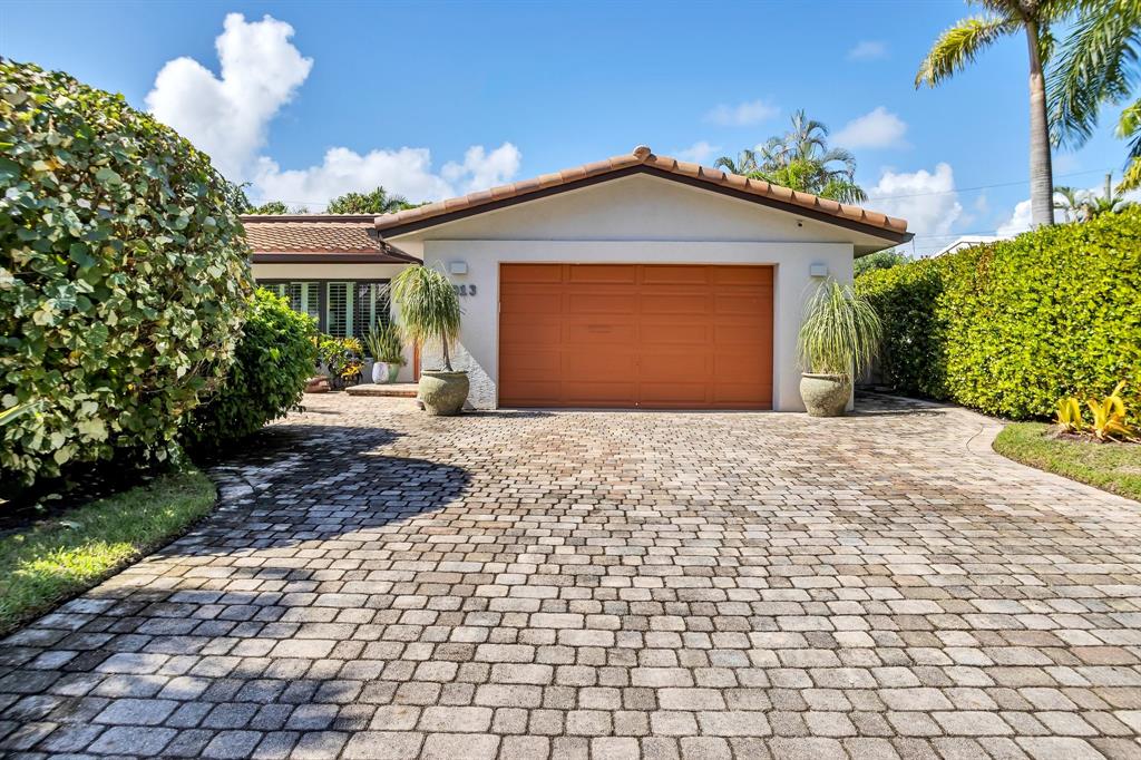 2013 Northeast 32nd Avenue Fort Lauderdale, FL 33305 - Photo 36 of 50 a front view of a house with a yard and garage