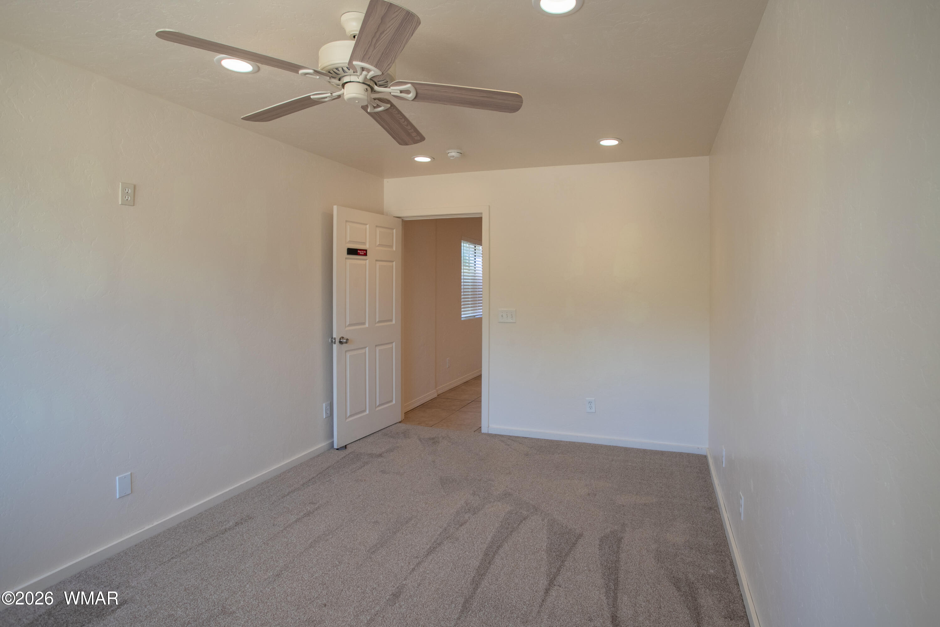 411 West Stratton Show Low, AZ 85901 - Photo 21 of 47 an empty room with fan and entrance