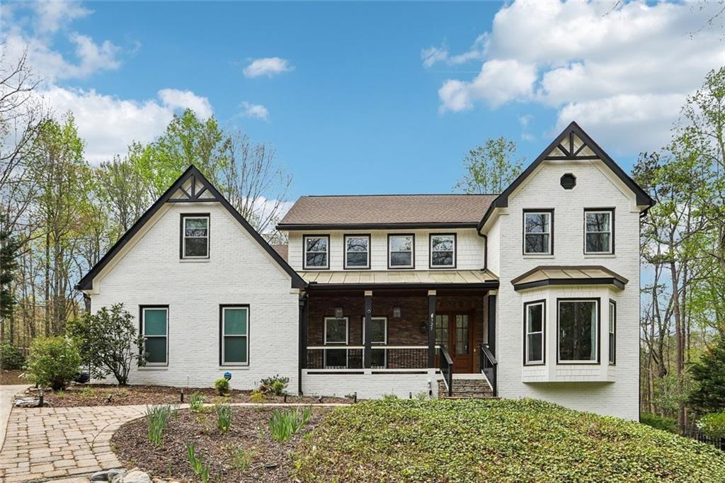 325 Destiny Trace Alpharetta, GA 30009 - Photo 1 of 1 a view of a white house with large windows and a small yard