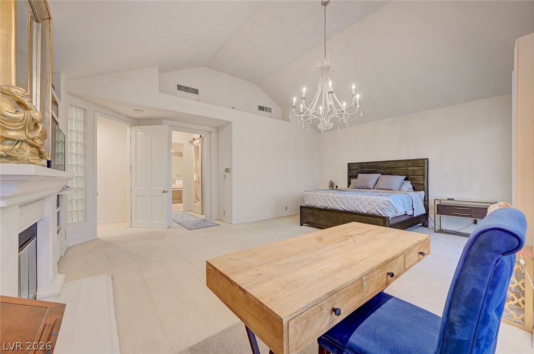 7995 Rio Rico Drive Las Vegas, NV 89113 - Photo 34 of 92 Lofty ceilings crown this generously proportioned primary bedroom, featuring a warm fireplace for cozy evenings.