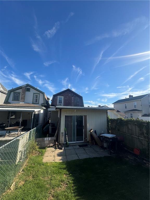 a front view of a house with a yard fire pit and outdoor seating