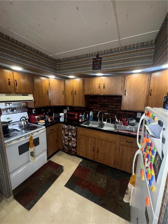 444 East Washington Street Rochester, PA 15074 - Photo 14 of 33 a kitchen with stainless steel appliances granite countertop a sink and wooden cabinets