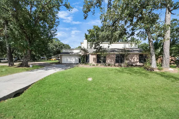 a view of house with yard and green space