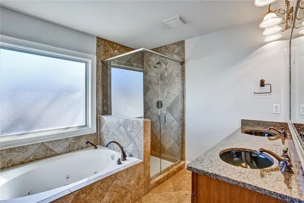 a bathroom with a tub and a sink