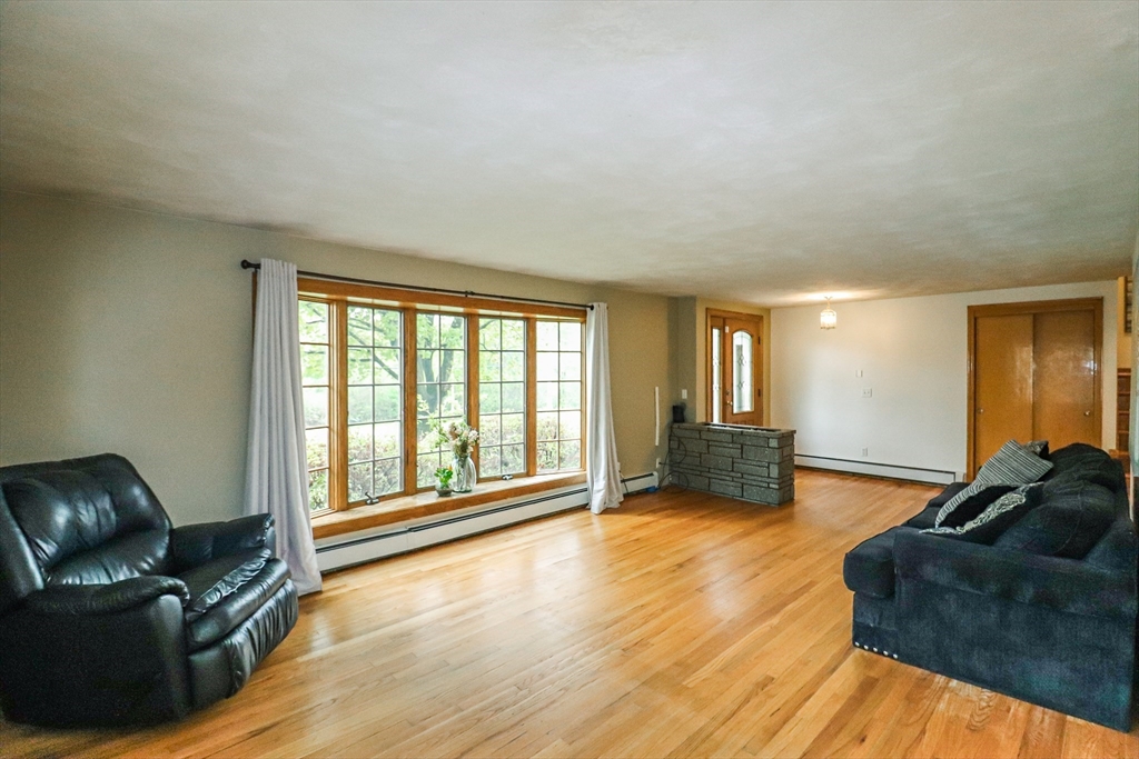 105 Gilbertville Road Ware, MA 01082 - Photo 12 of 41 a living room with furniture and a large window