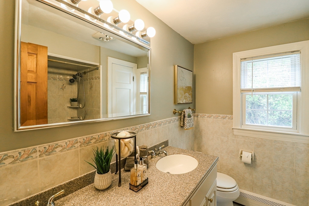 105 Gilbertville Road Ware, MA 01082 - Photo 19 of 41 a bathroom with a granite countertop sink toilet a mirror and shower