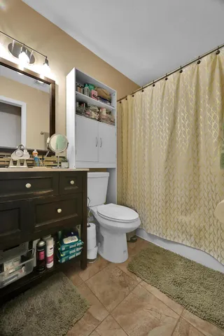 a bathroom with a sink vanity mirror and toilet