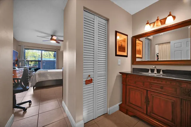 a en suite bathroom with a sink a vanity and mirror