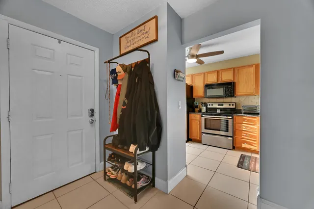 a walk in closet with wooden floor