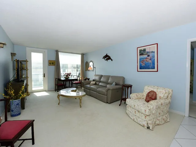 a living room with furniture rug and window