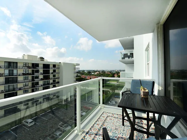 a balcony with table and chairs