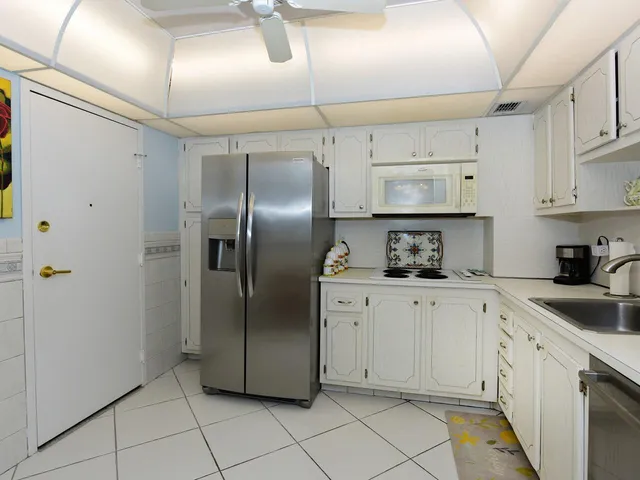 a kitchen with cabinets and stainless steel appliances
