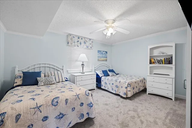 a bedroom with two beds and a chandelier