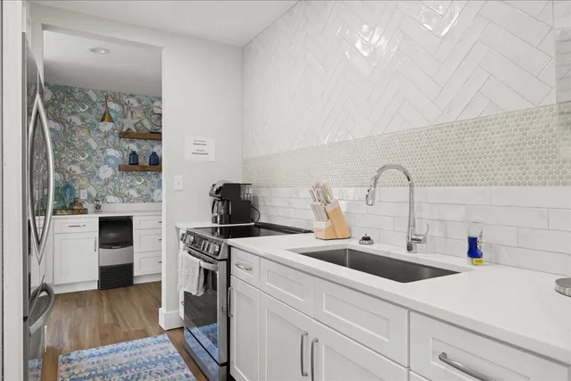 a kitchen with a sink cabinets and stainless steel appliances