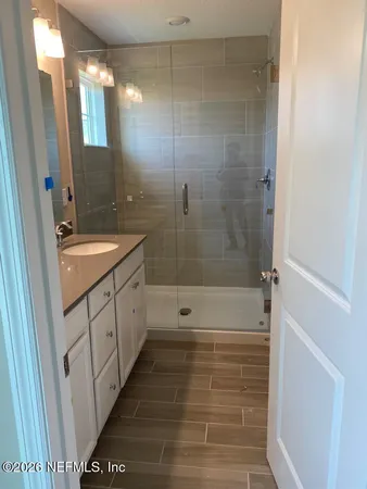 a bathroom with a shower and a sink