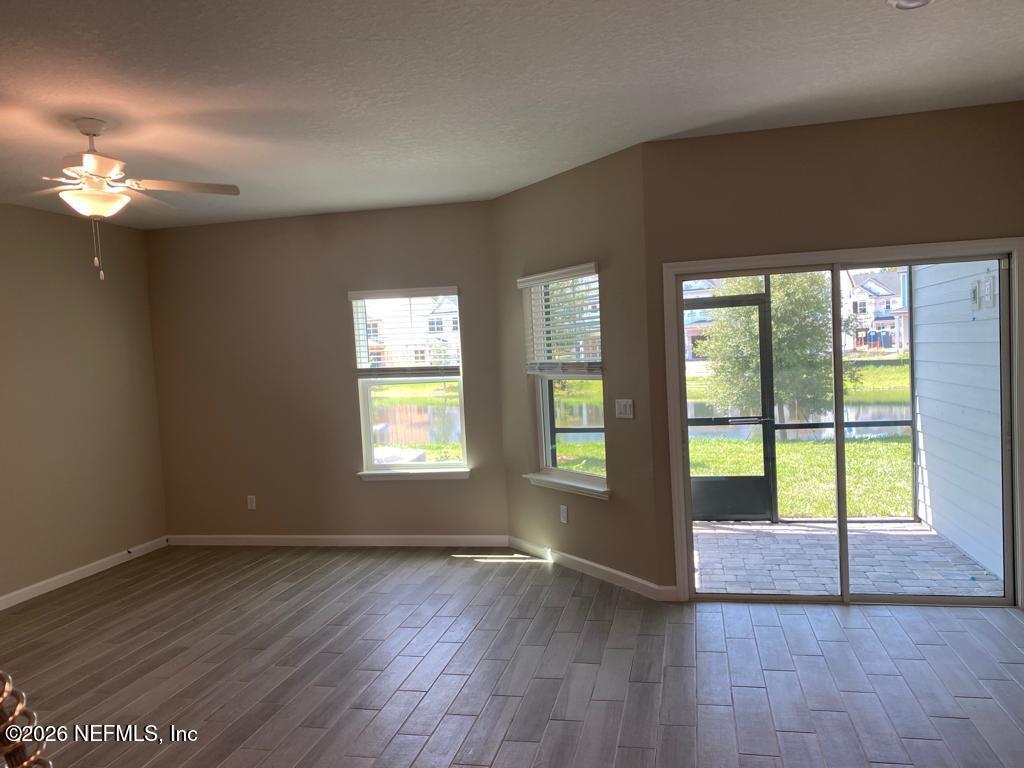 243 Boracay Circle St. Johns, FL 32259 - Photo 6 of 20 a view of an empty room with wooden floor and a window