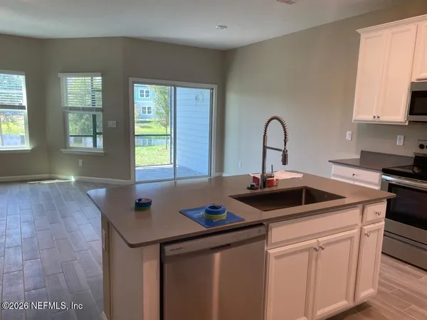 a kitchen with a sink and cabinets