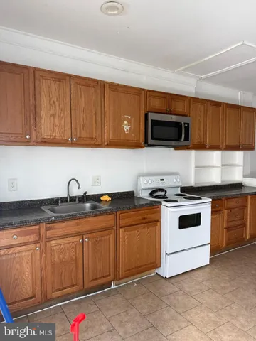 a kitchen with granite countertop a sink and cabinets