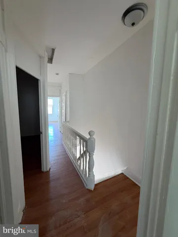 a view of hallway with wooden floor