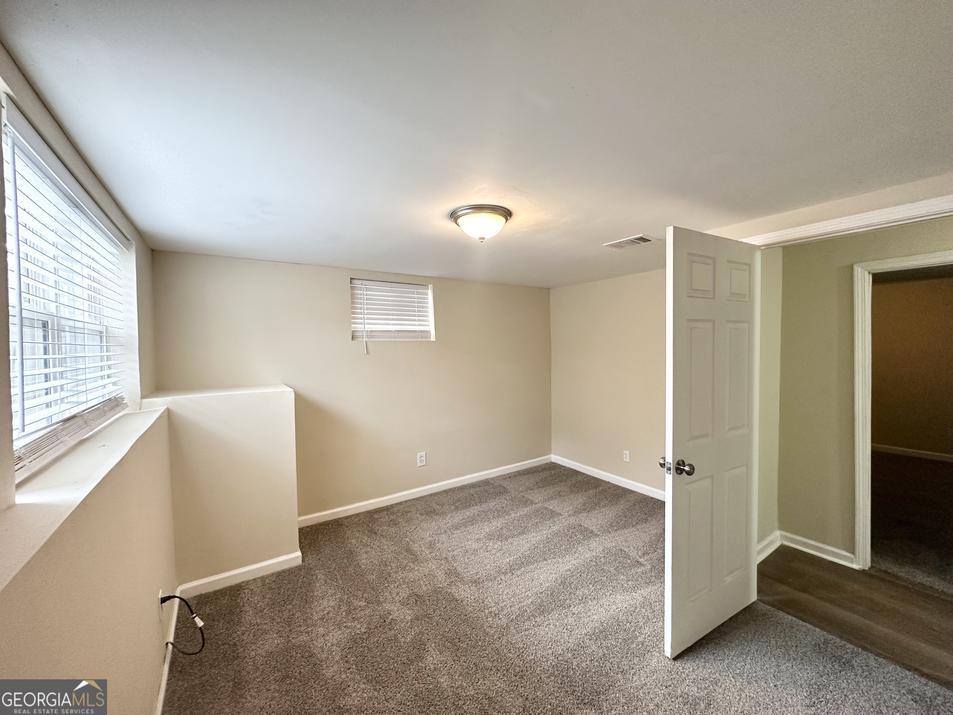 4436 Malibu Drive Decatur, GA 30035 - Photo 12 of 17 an empty room with windows and closet