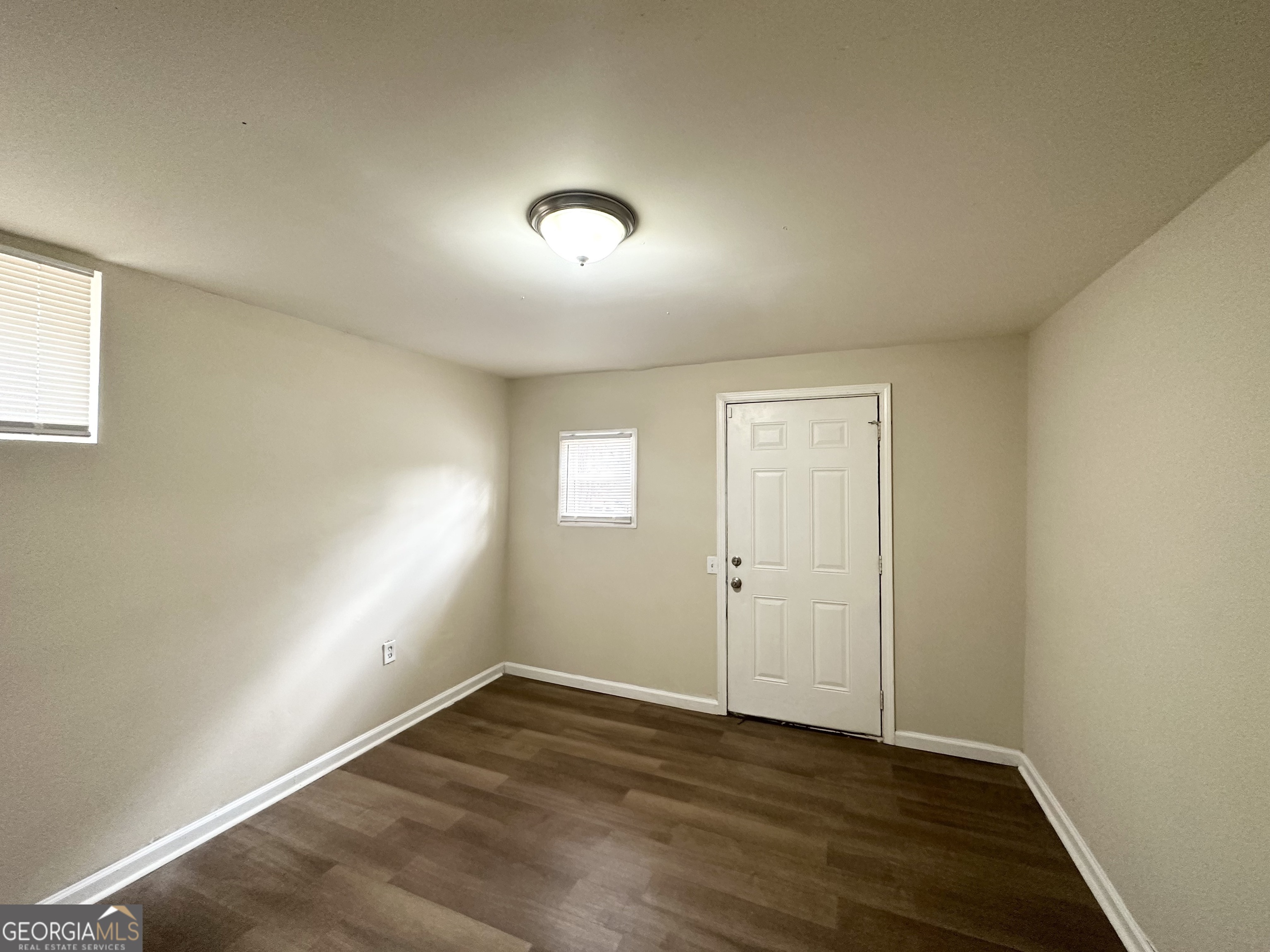 4436 Malibu Drive Decatur, GA 30035 - Photo 15 of 17 an empty room with wooden floor and windows