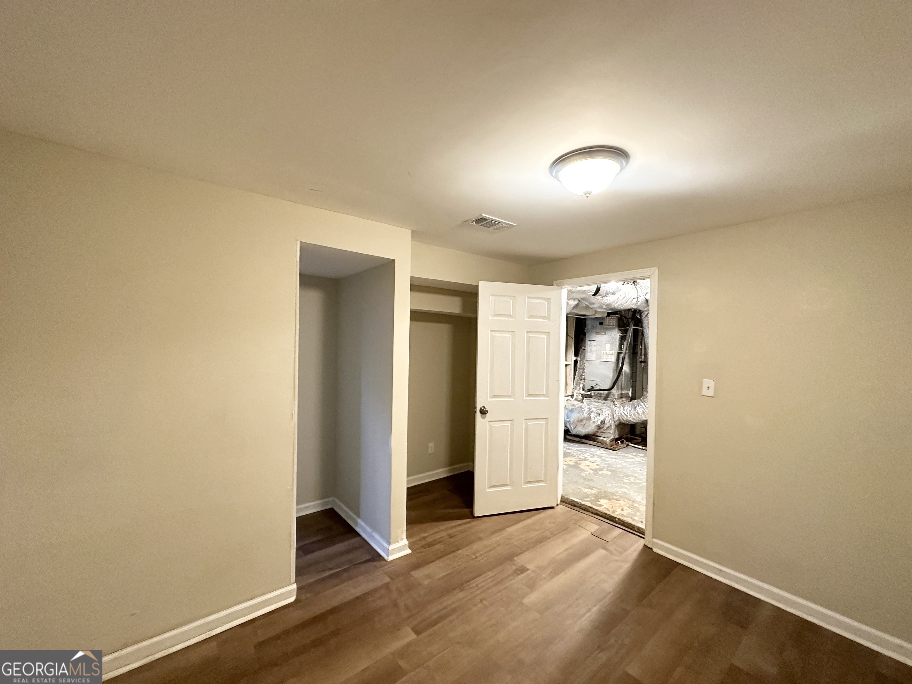 4436 Malibu Drive Decatur, GA 30035 - Photo 16 of 17 an empty room with wooden floor