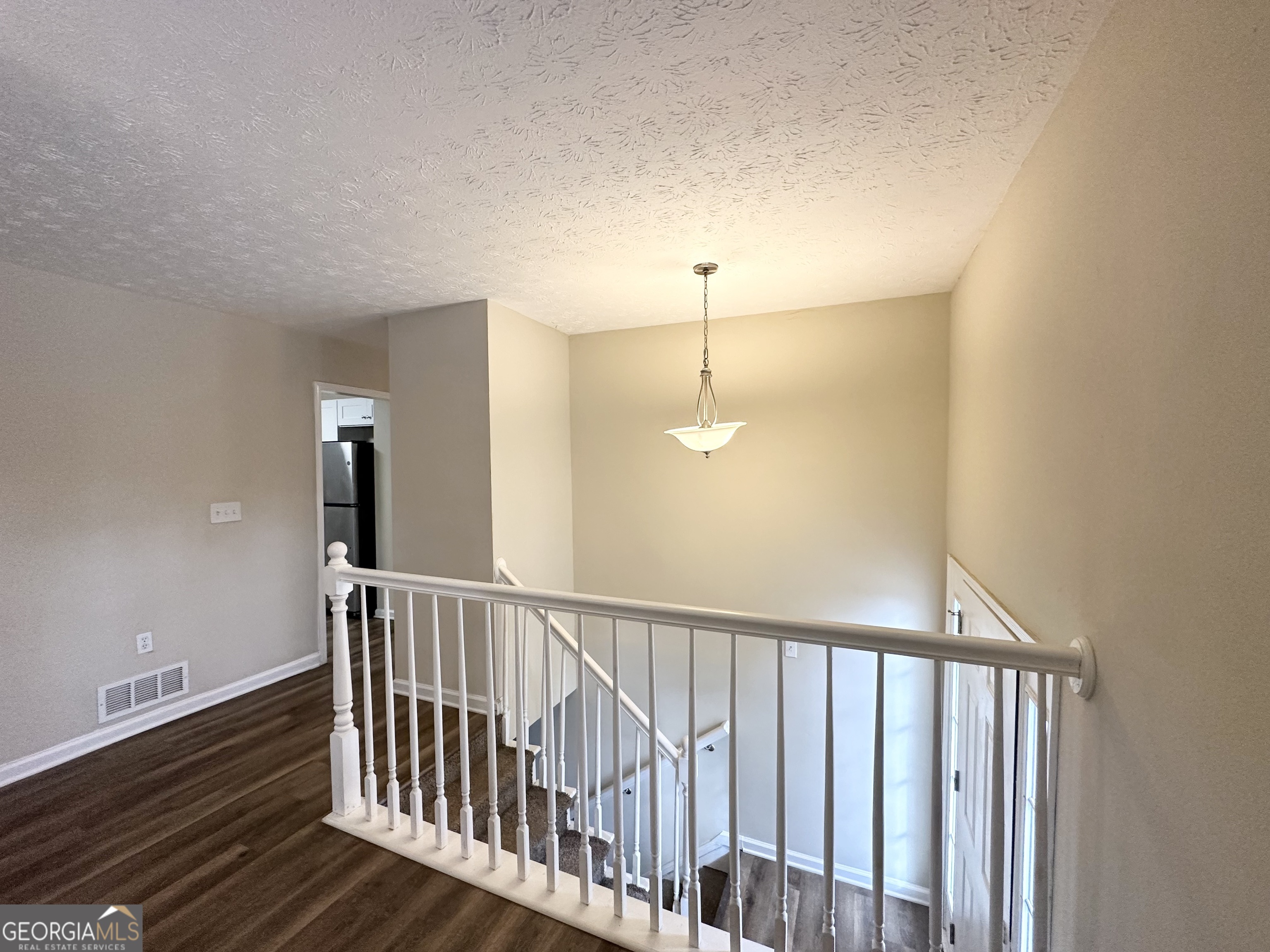 4436 Malibu Drive Decatur, GA 30035 - Photo 3 of 17 a view of staircase with railing and a chandelier
