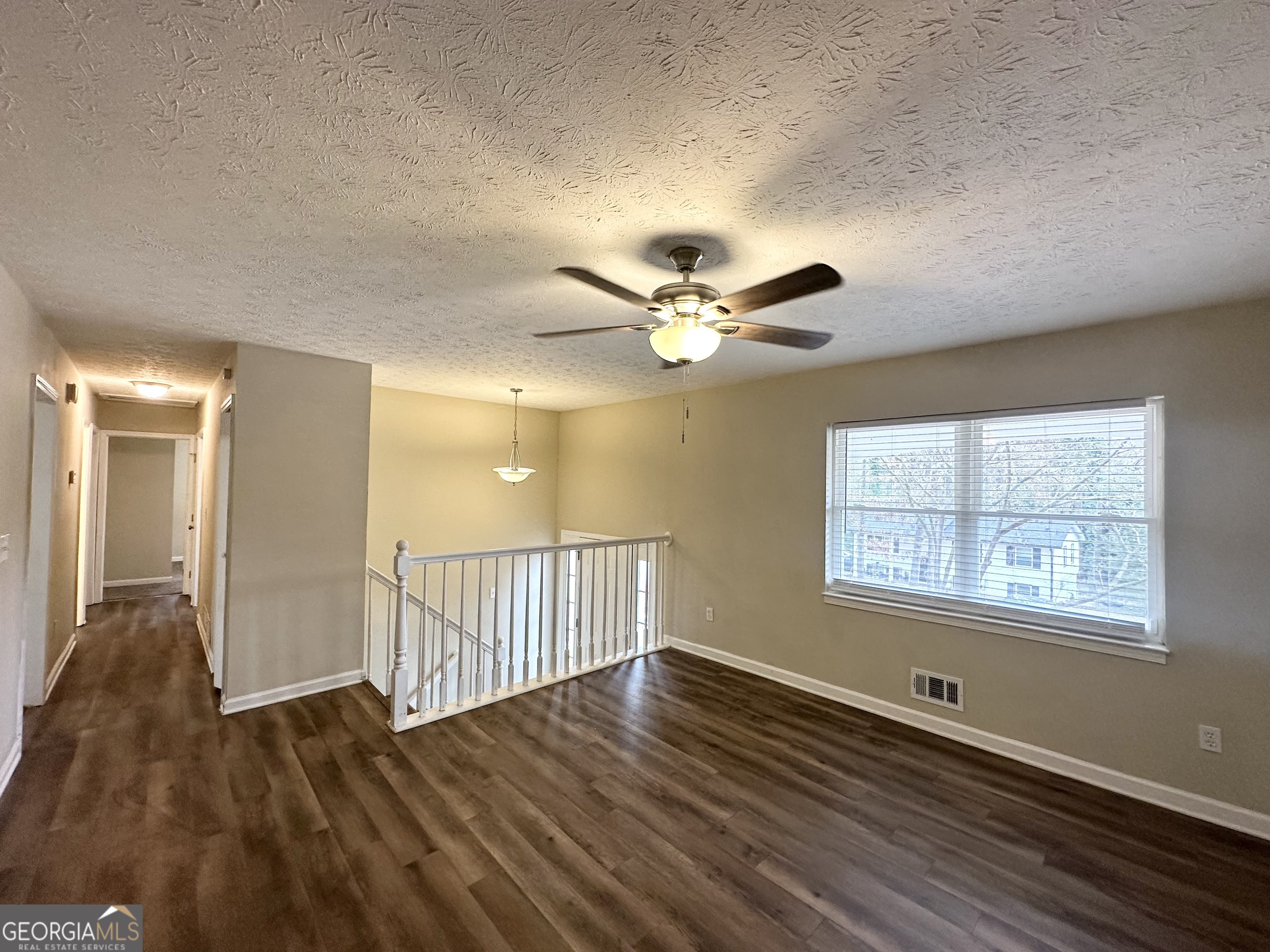 4436 Malibu Drive Decatur, GA 30035 - Photo 4 of 17 a view of an empty room with wooden floor and a window