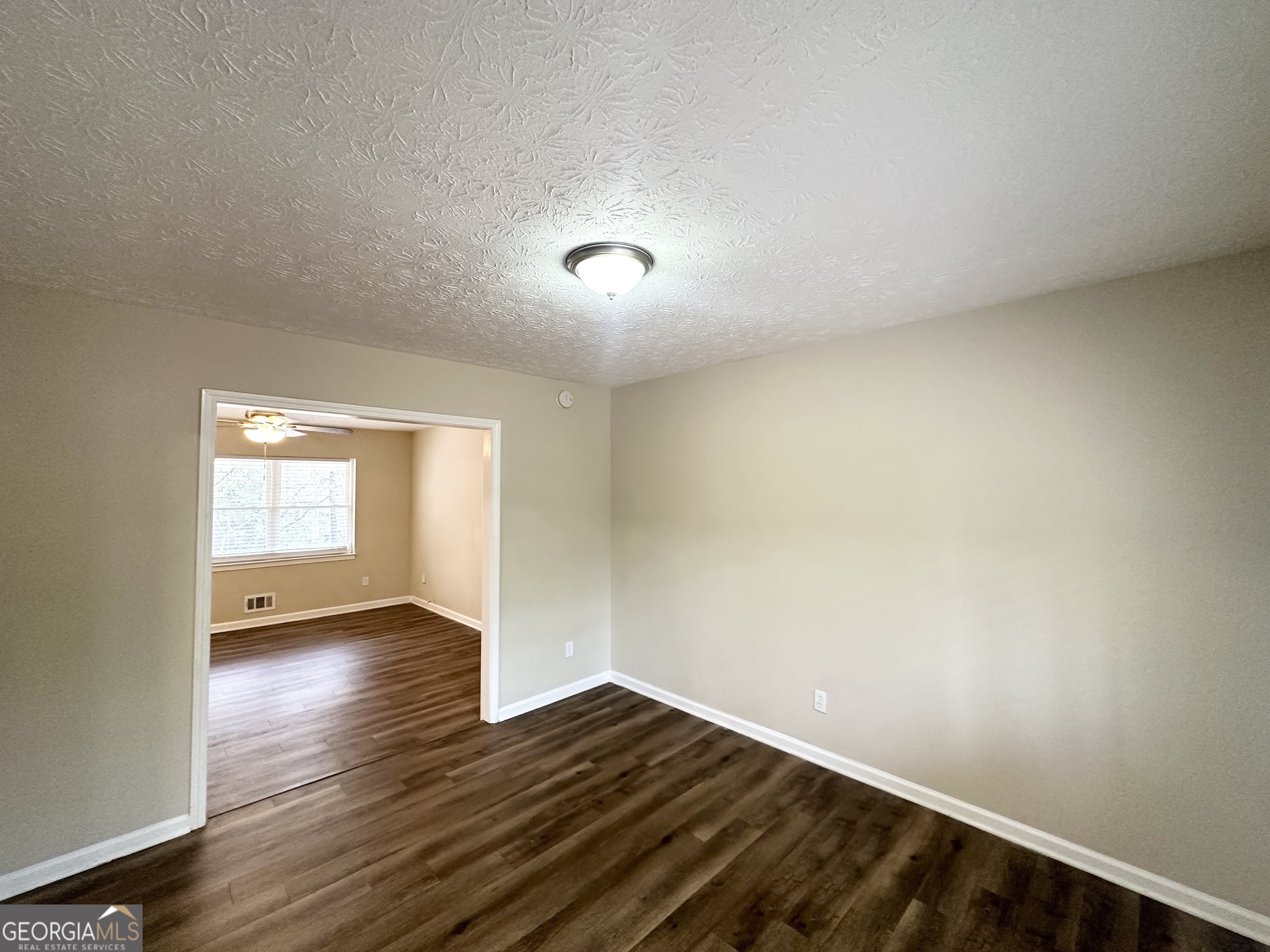4436 Malibu Drive Decatur, GA 30035 - Photo 5 of 17 an empty room with wooden floor and windows