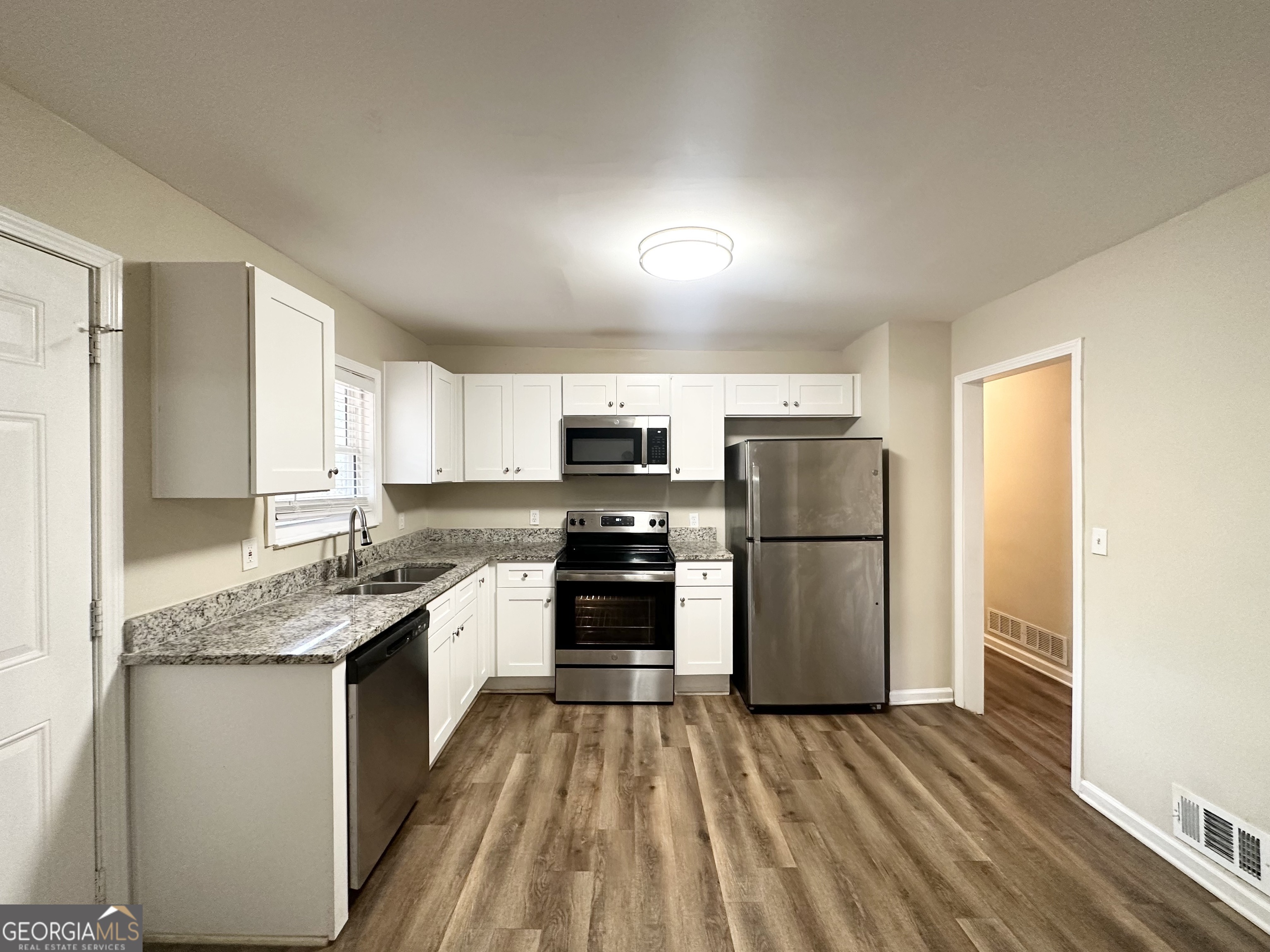 4436 Malibu Drive Decatur, GA 30035 - Photo 6 of 17 a kitchen with stainless steel appliances granite countertop a stove a refrigerator and a sink