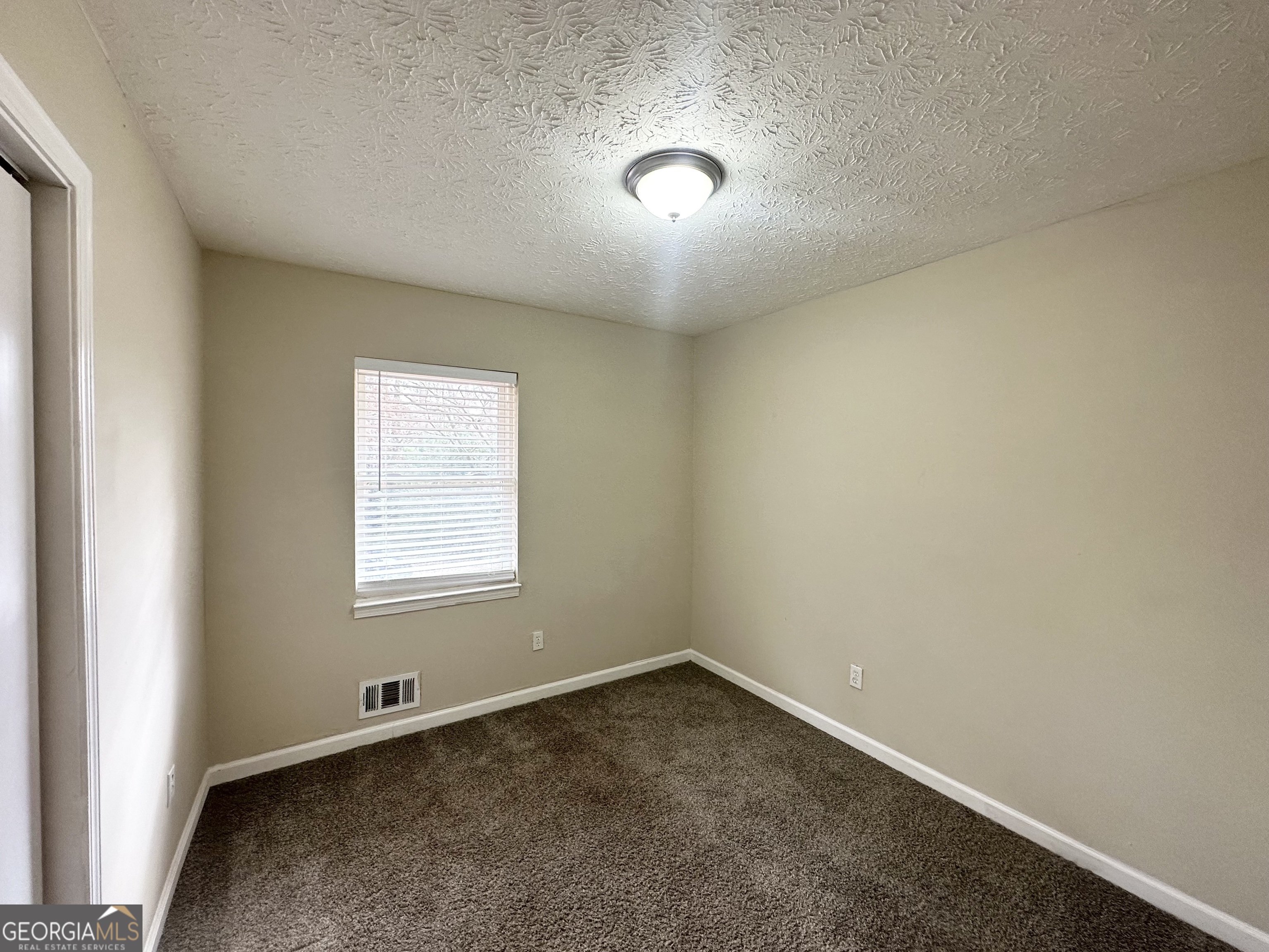 4436 Malibu Drive Decatur, GA 30035 - Photo 7 of 17 an empty room with a window
