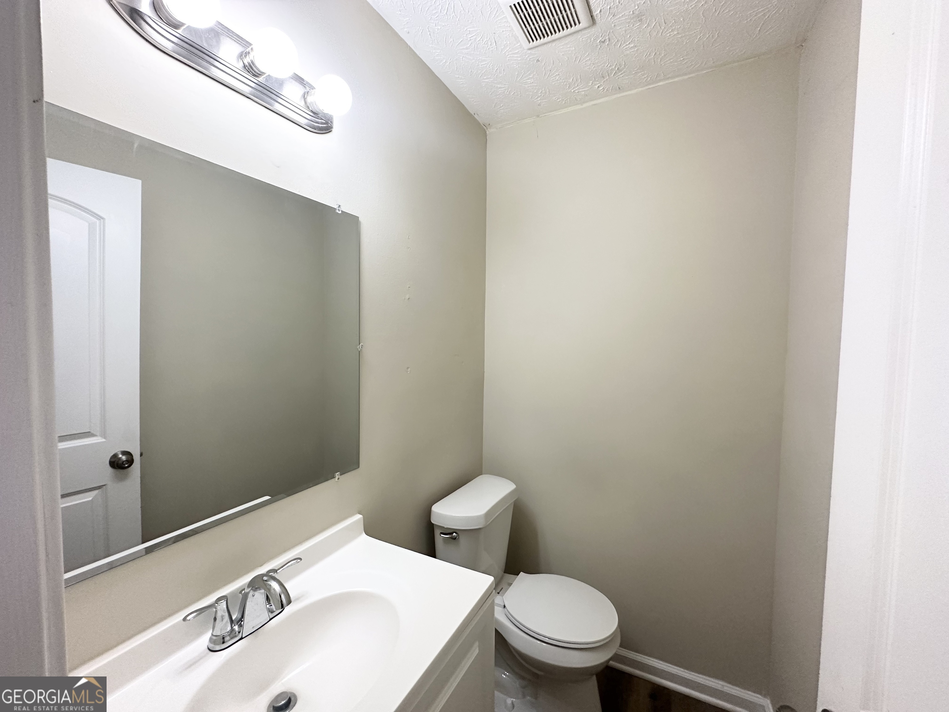 4436 Malibu Drive Decatur, GA 30035 - Photo 10 of 17 a bathroom with a sink a toilet and a mirror