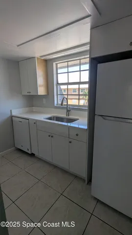 a stove top oven sitting inside of a kitchen
