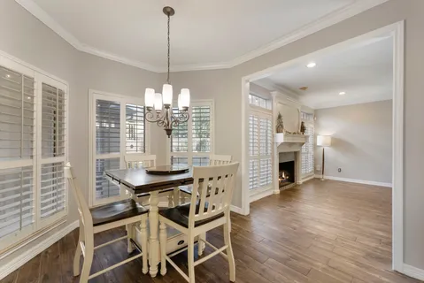 a view of a dining room with furniture and window