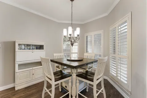 a spacious bedroom with a bed flat screen tv and window