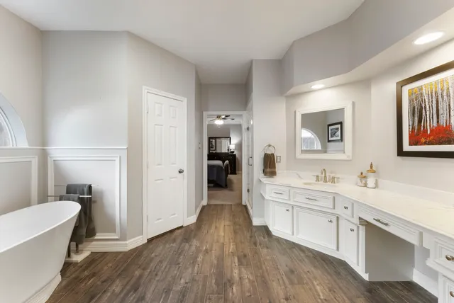 a large bathroom with a sink a toilet a mirror and shower