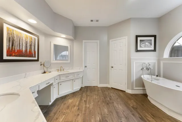 a spacious bathroom with a bathtub sink and toilet
