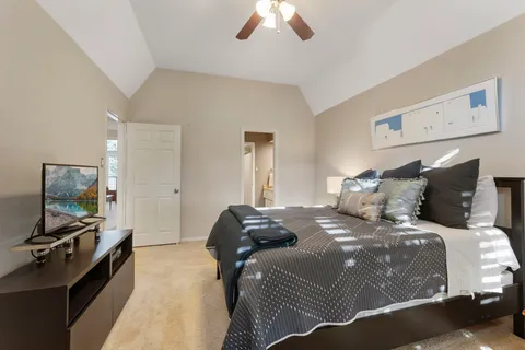 a bathroom with a granite countertop toilet and a sink