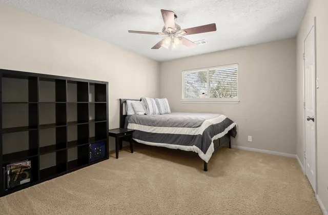 a spacious bedroom with a bed and a walk in closet