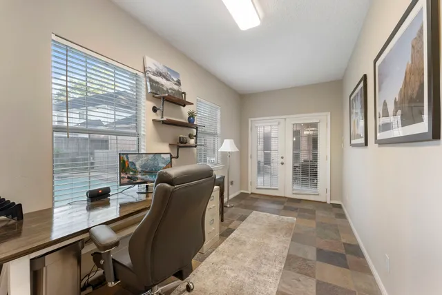 a view of a white house with a swimming pool and a yard