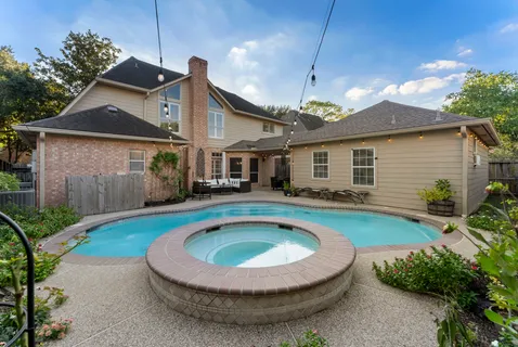 a view of a patio with dining table and chairs