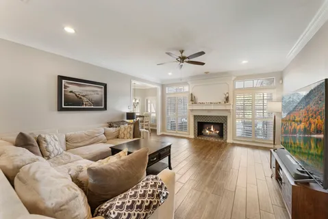 a view of a dining room with furniture a chandelier and wooden floor