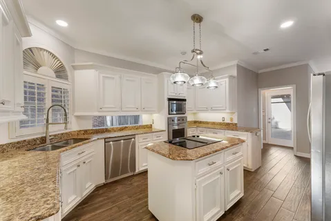 a kitchen with stainless steel appliances granite countertop a sink stove and refrigerator